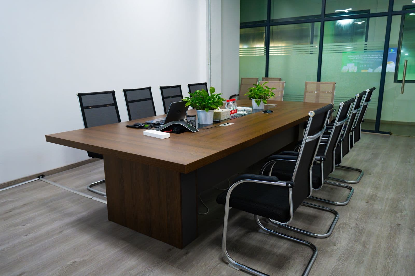 A modern boardroom with conference table and chairs