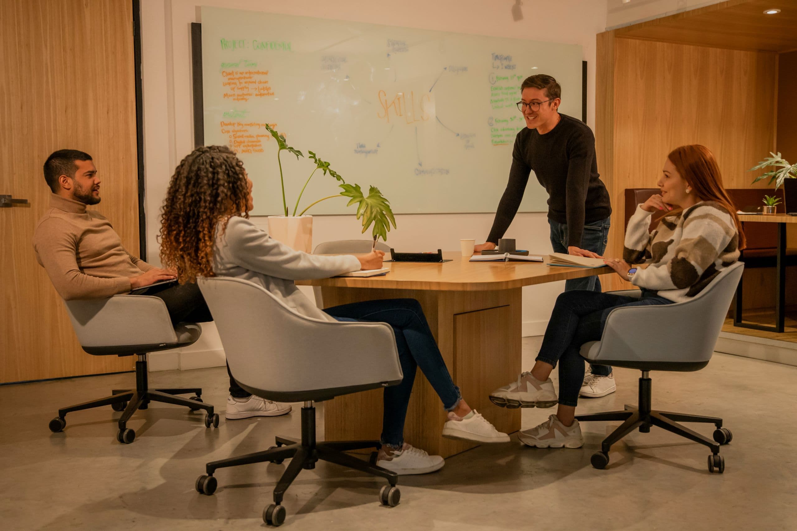 A group of people sitting around a wooden table