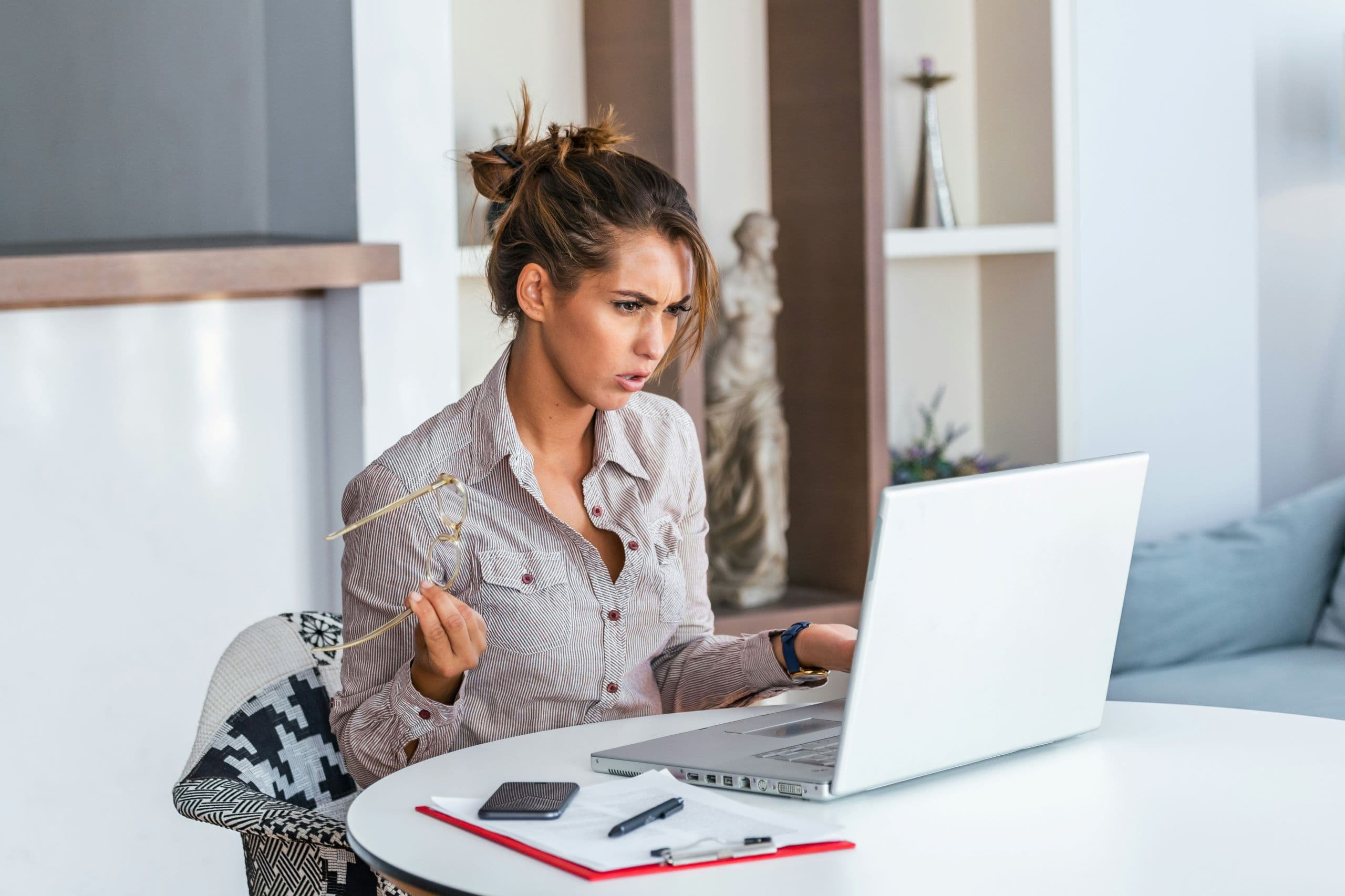 A woman sitting at a table with a laptop