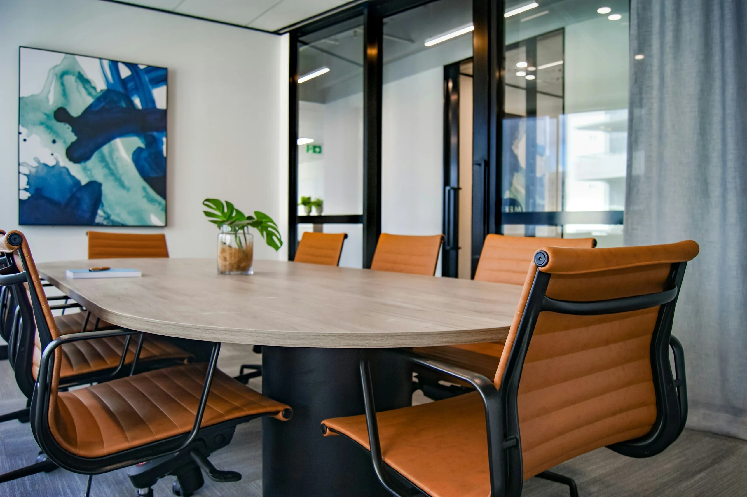 A modern boardroom with a large table and chairs