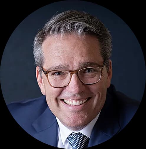 A man in a suit and tie smiling