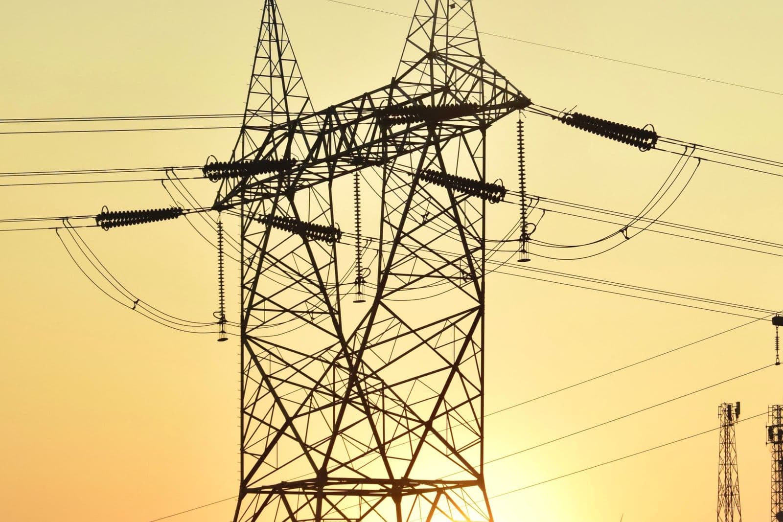 High-voltage power lines at sunset