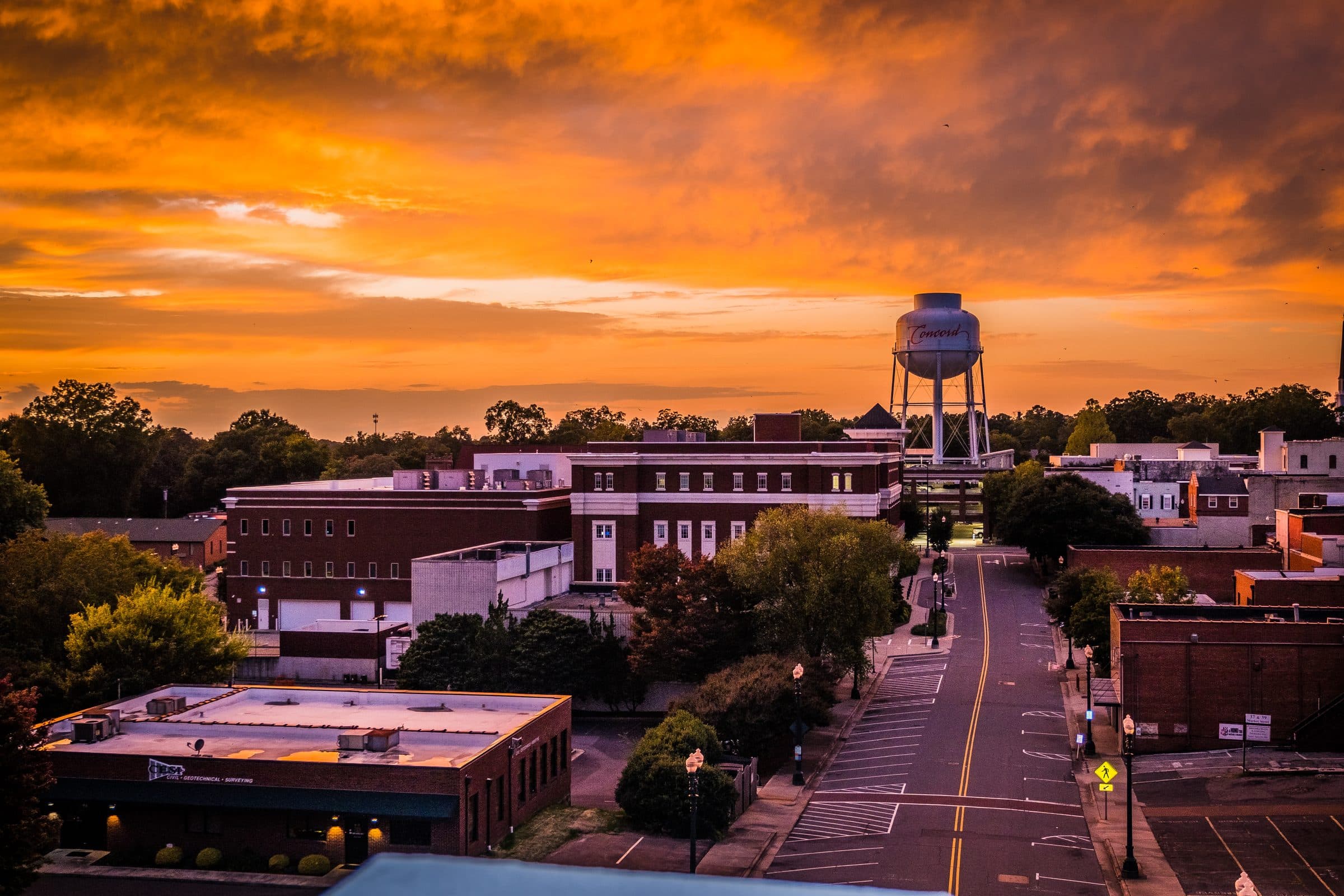 A small town at sunset, seen from above, with its water tower